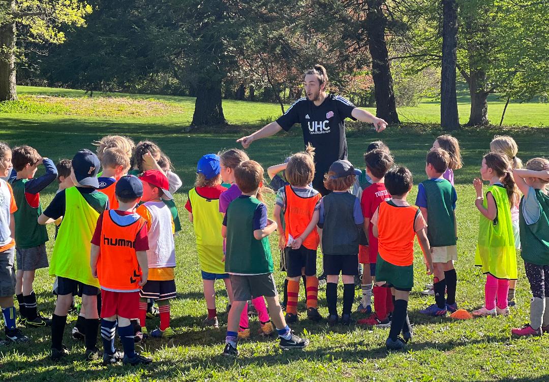 Coach talking with young soccer players